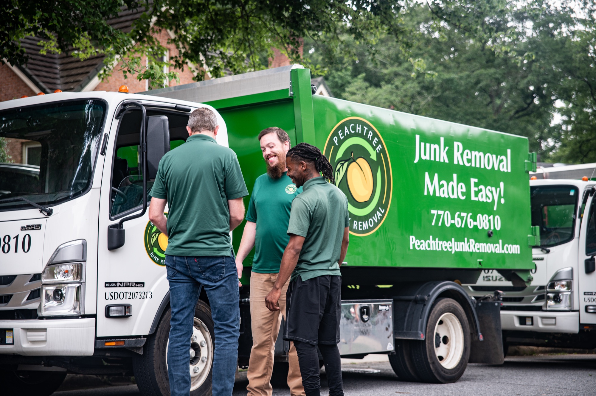 Peachtree crew members sharing a laugh beside their truck